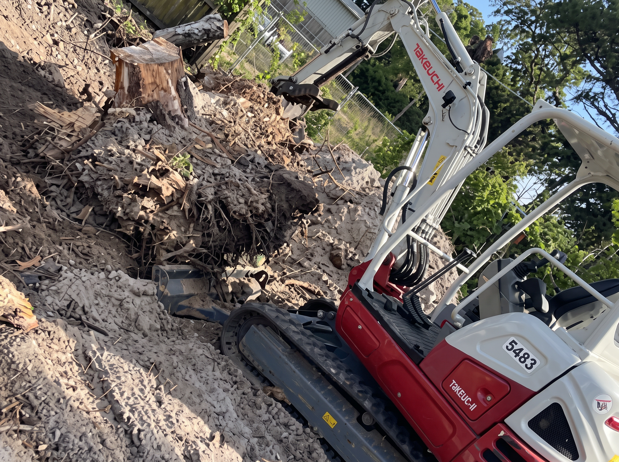 Excavator clearing a lot of roots and brush