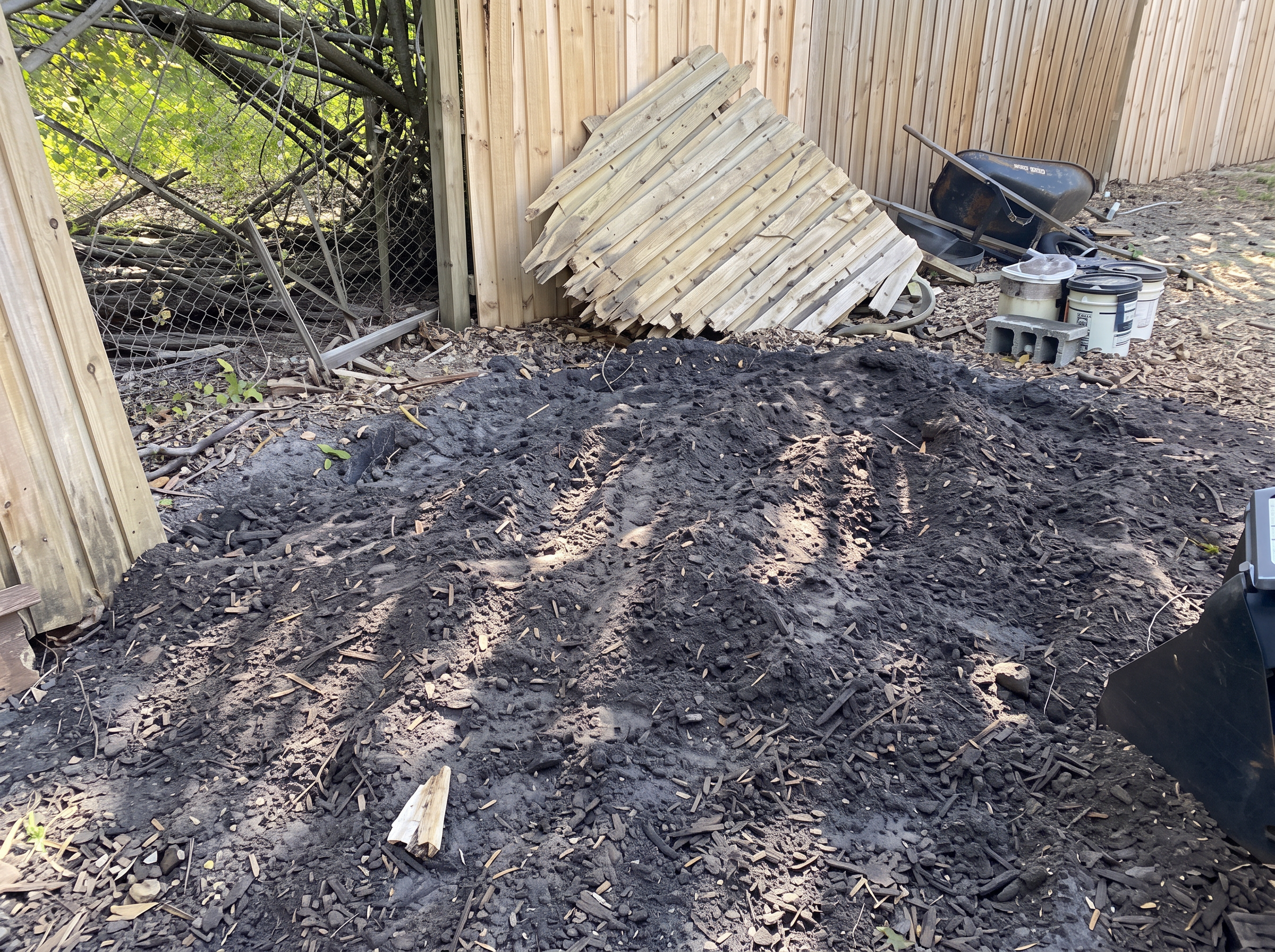 Ground cleared of debris along a wood fence